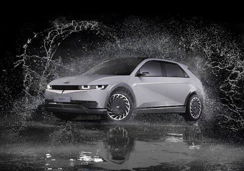 a white car is splashing in the water