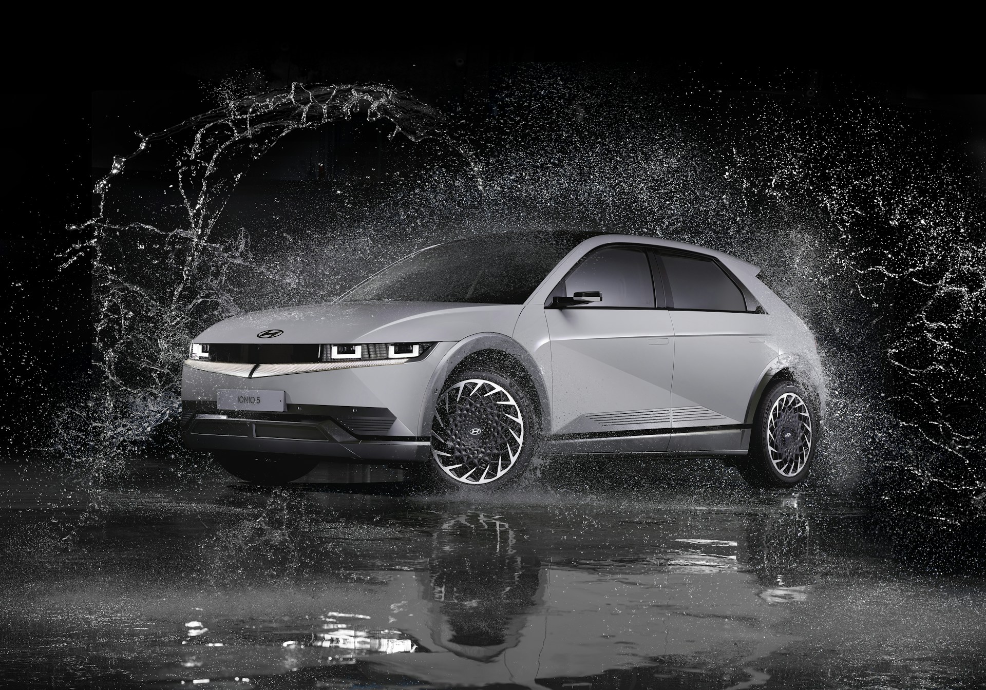 a white car is splashing in the water