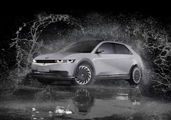 a white car is splashing in the water