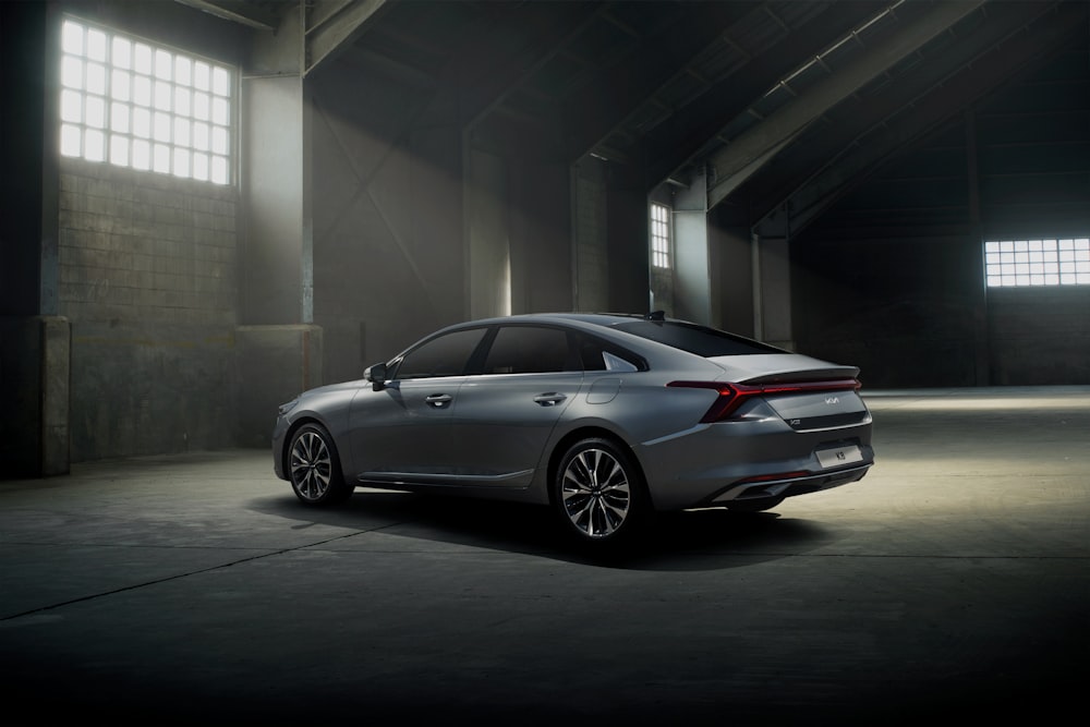 a silver car parked in a dark garage