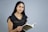 a woman in a black dress holding a book