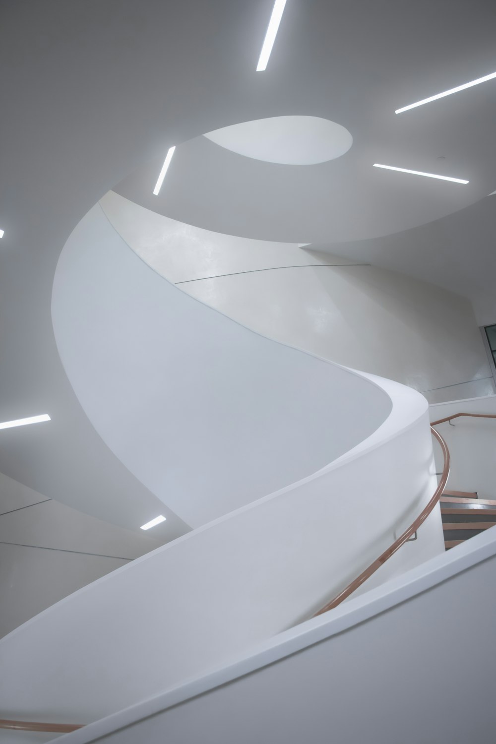 a spiral staircase in a building with white walls