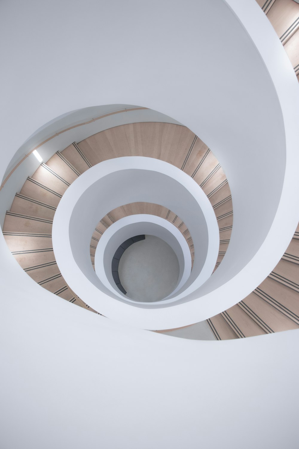 a spiral staircase in a building with white walls