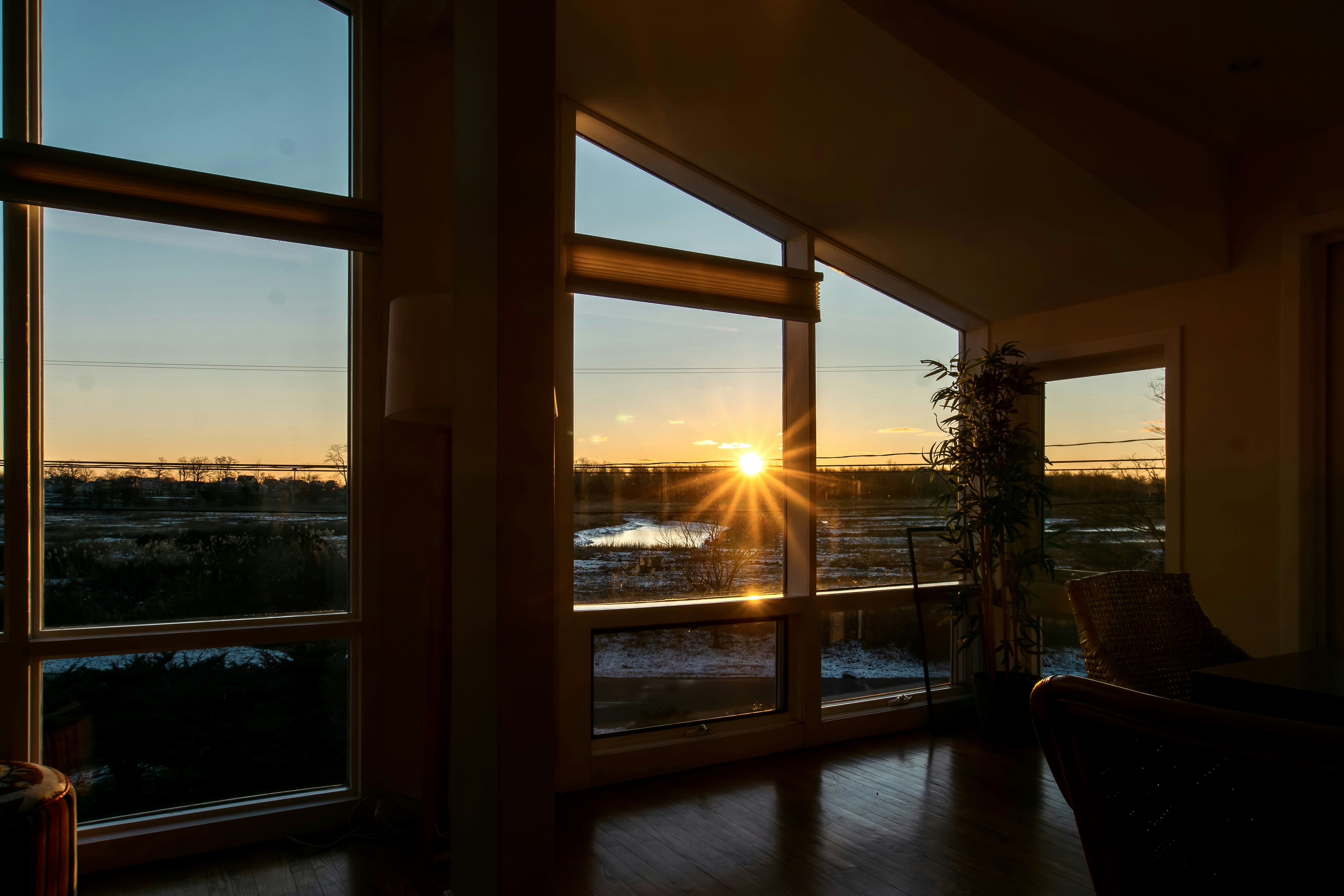 The sun is setting through the windows of a house photo – Free Norwalk ...