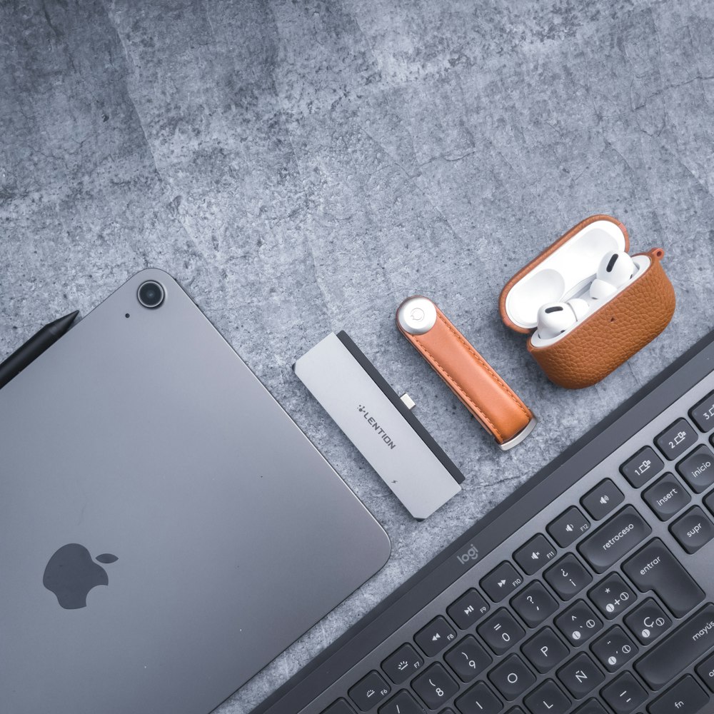 an apple laptop computer sitting next to a keyboard