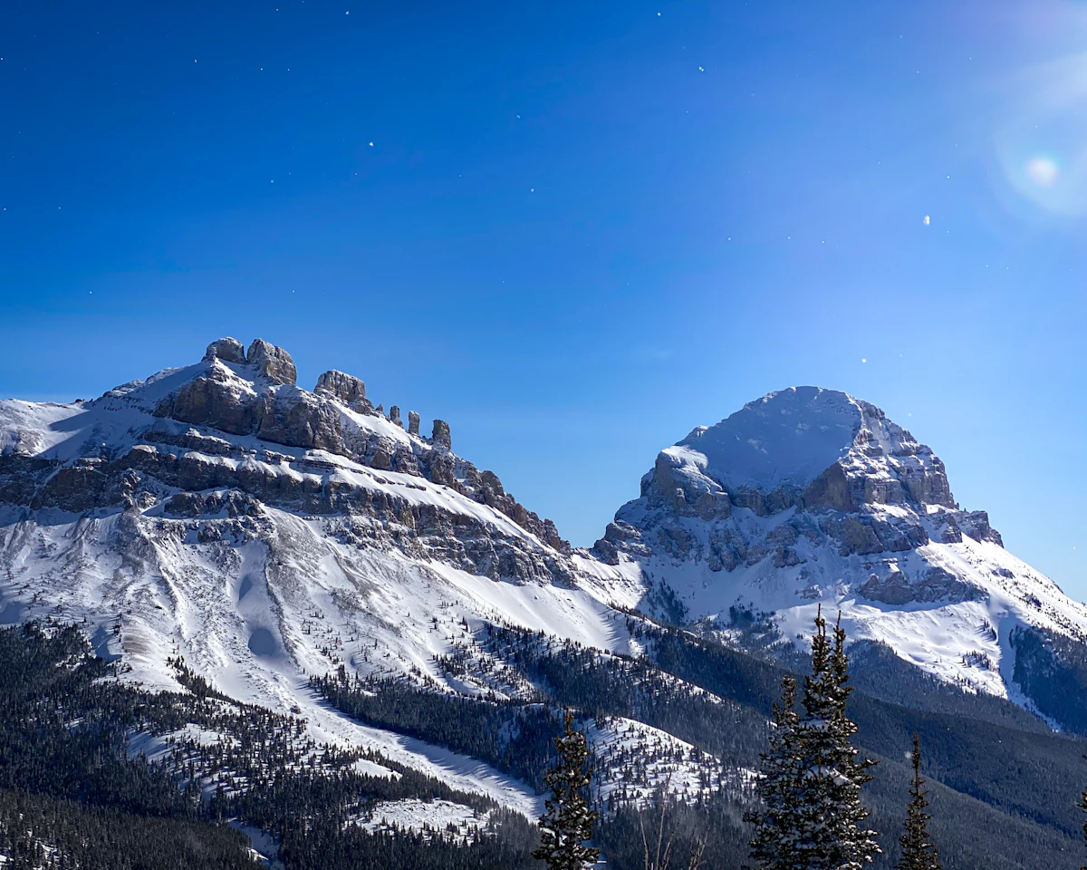 Crowsnest Mountain and a craggy ridge beside it, deep in winter snow
