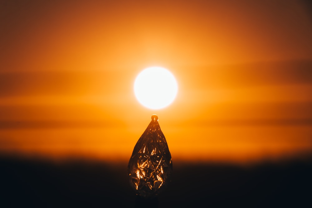 the sun is setting behind a diamond in the sky