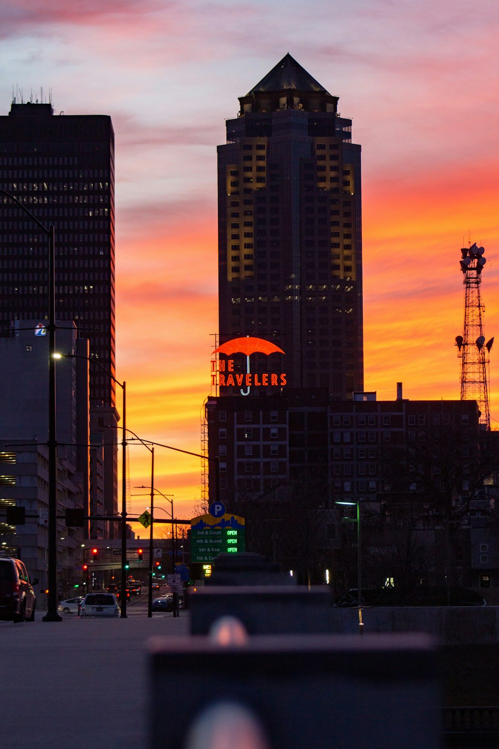 a sunset view of a city with tall buildings