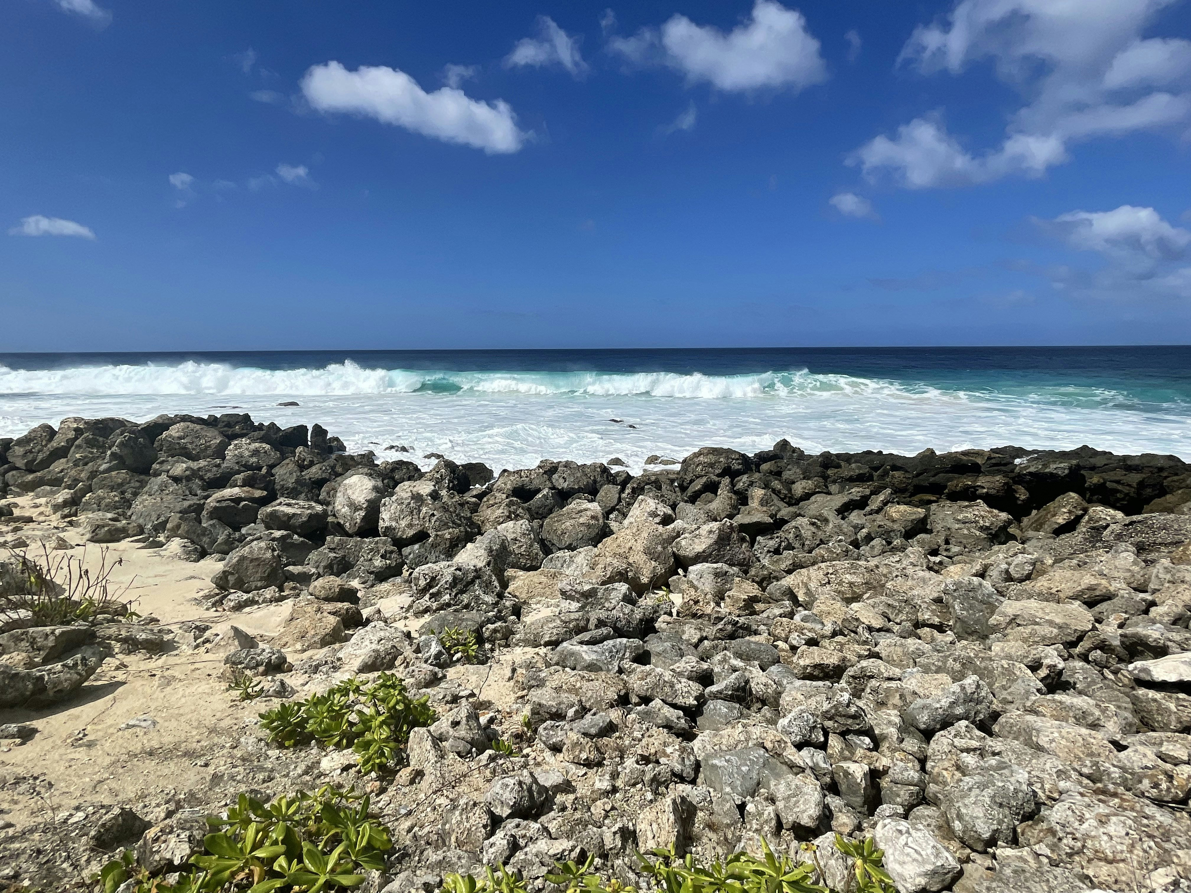 a view of the ocean from a rocky beach