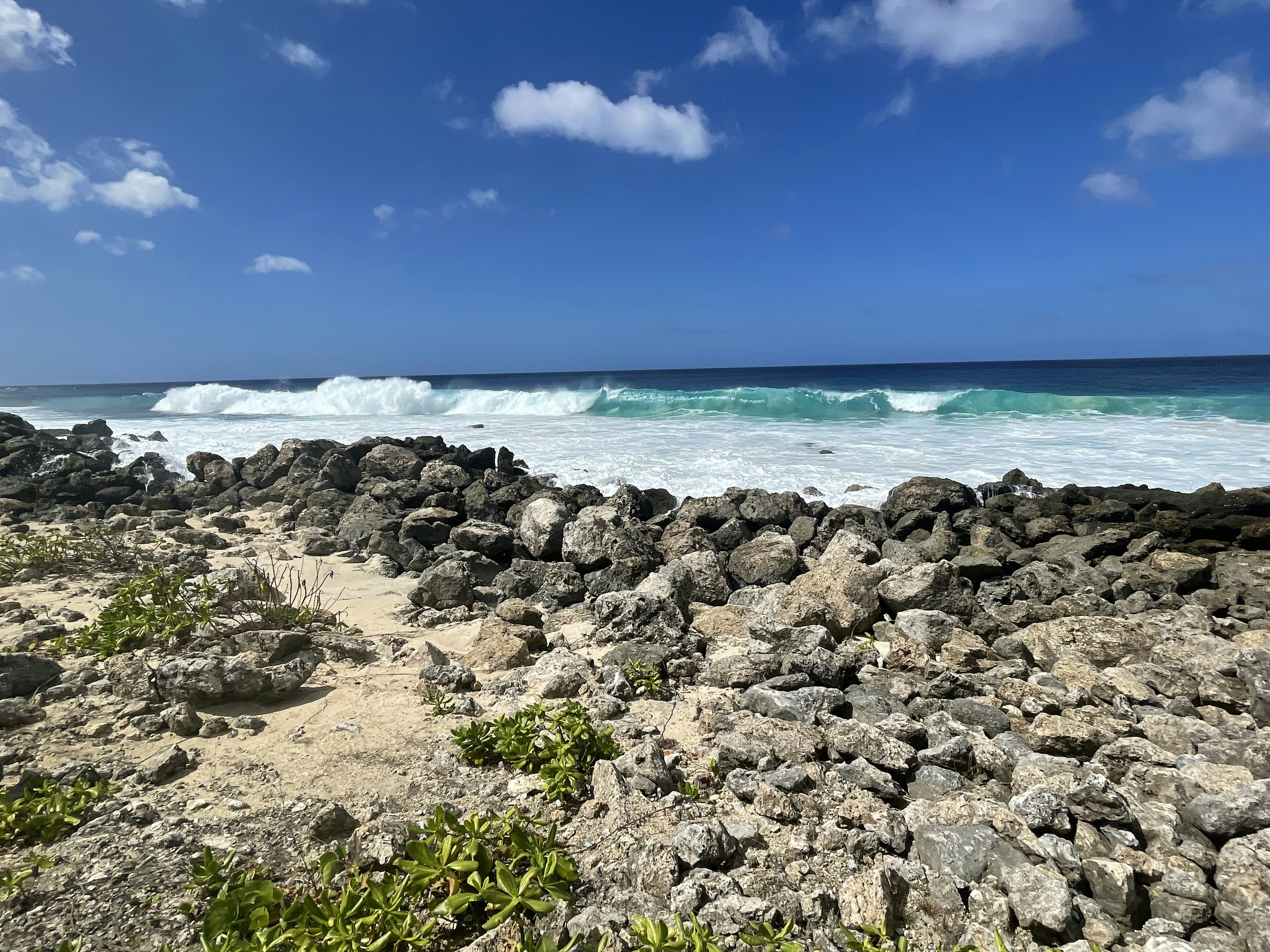 a rocky beach with waves coming in from the ocean