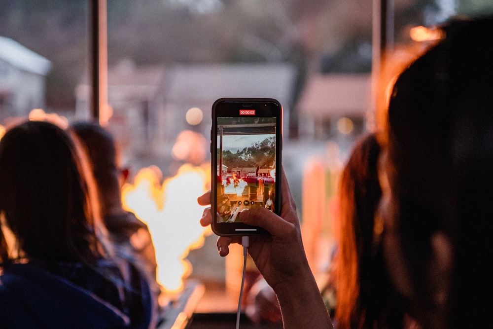 a woman taking a picture of a group of people