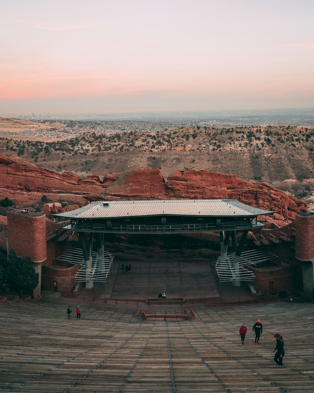 a stage with steps leading to it and people walking around