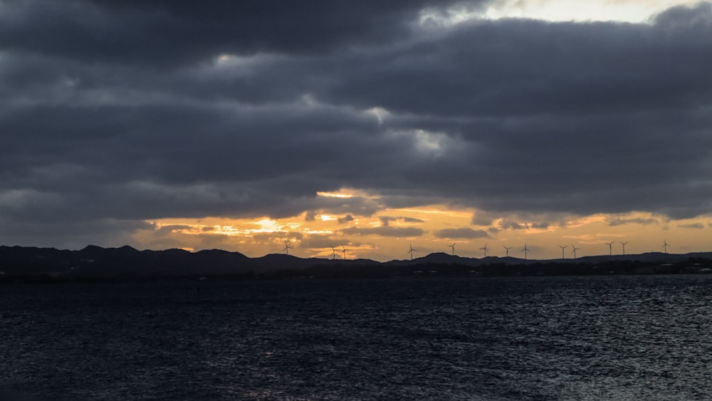 a large body of water under a cloudy sky