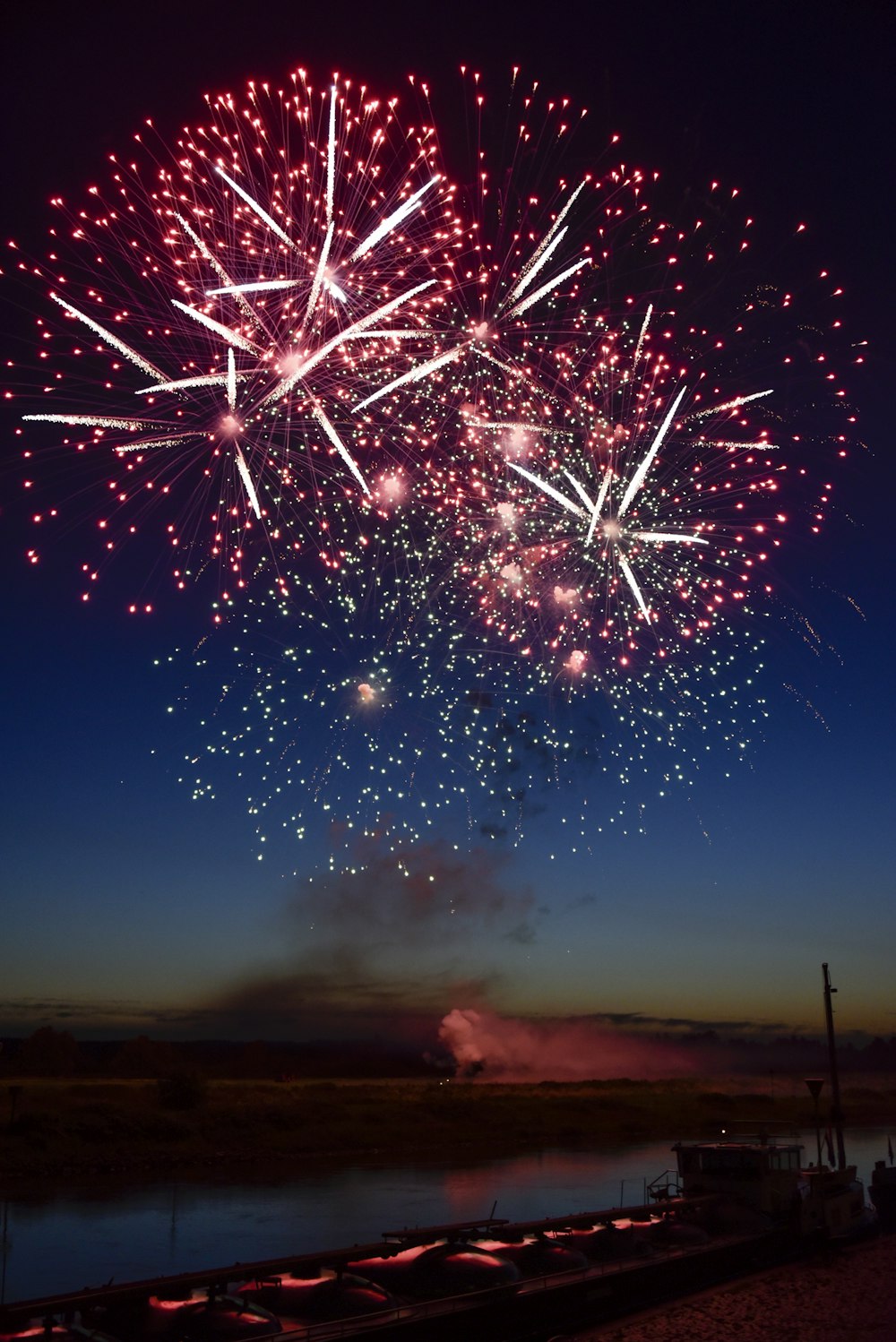 a large fireworks is lit up in the night sky