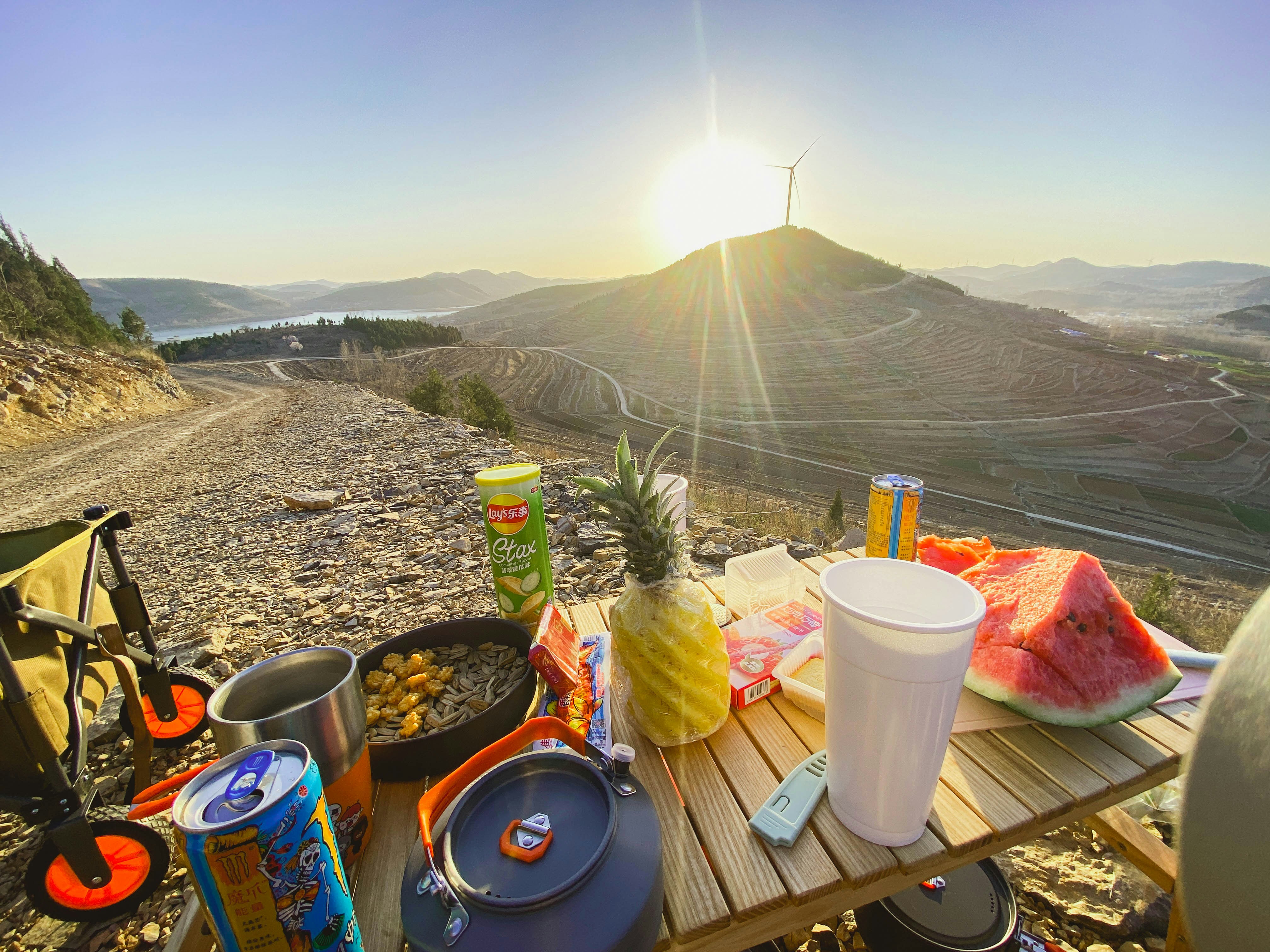 a picnic table with food and drinks on it
