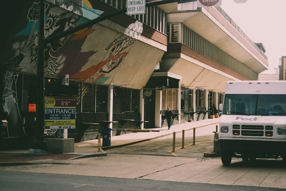 a white truck parked on the side of a street