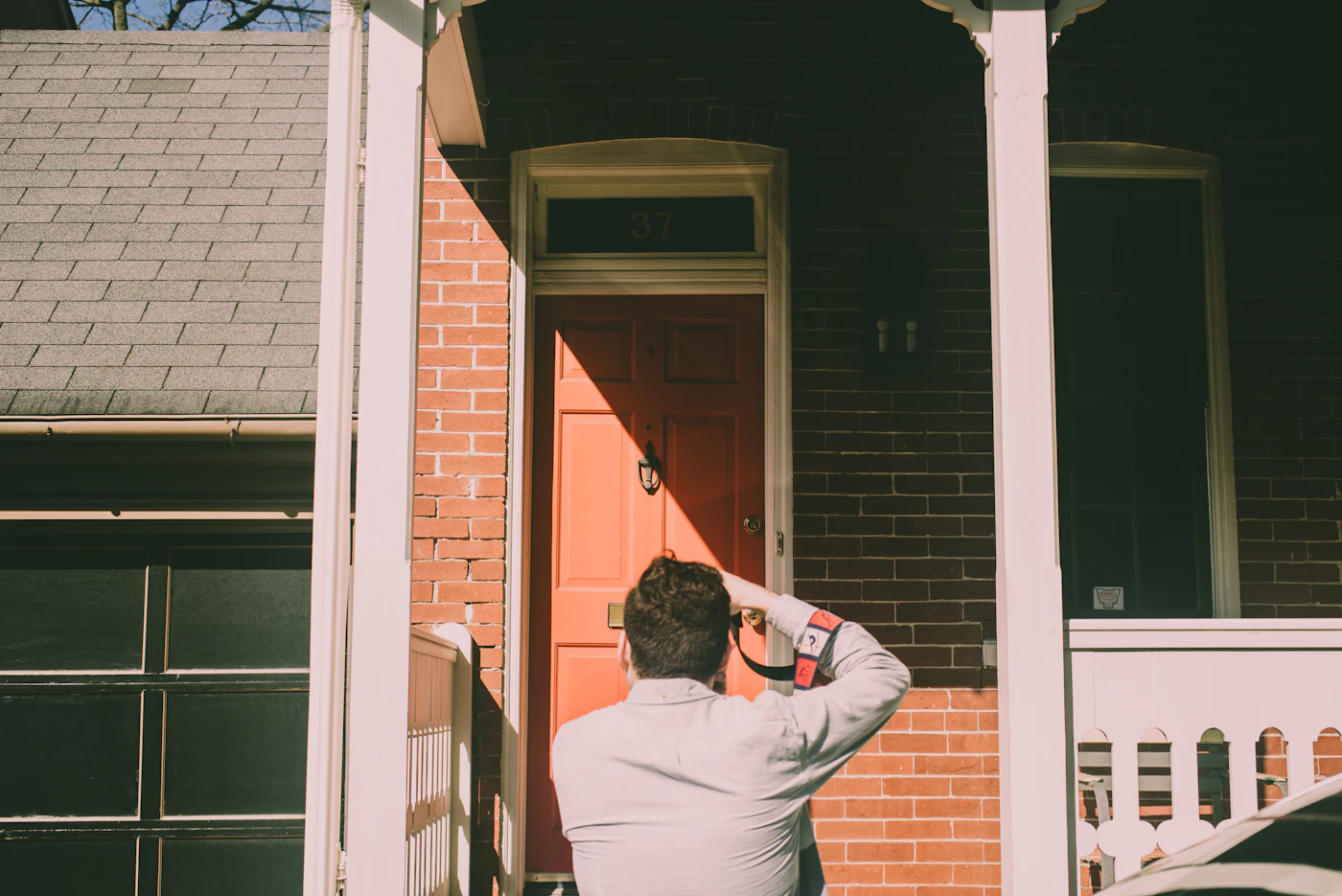 Inspector evaluating a residential property entryway