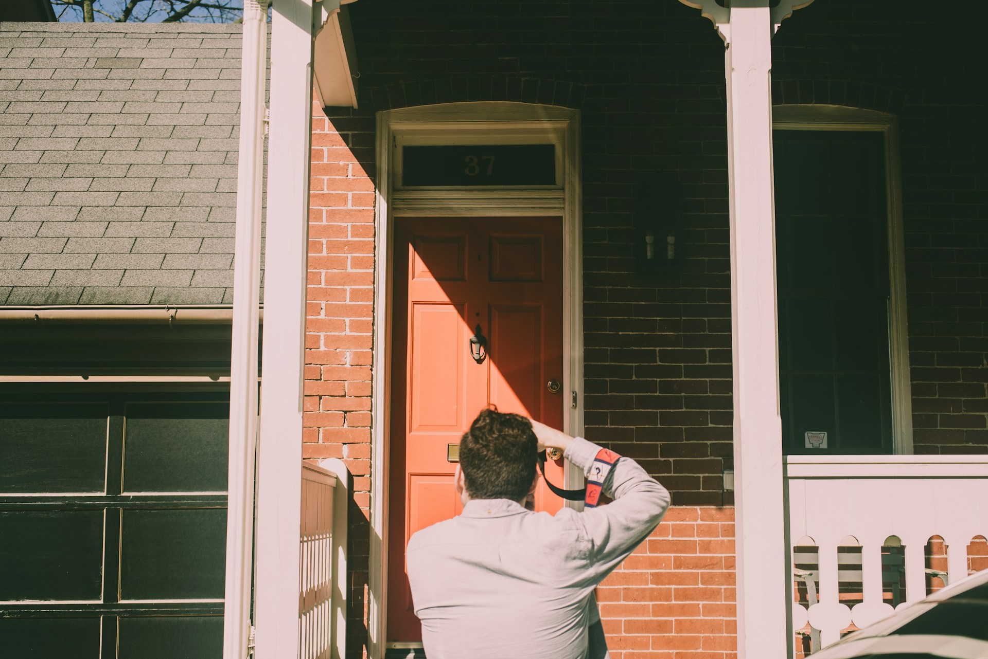 a person standing in front of a red door