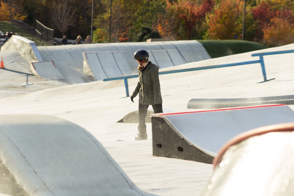 a man standing on a skateboard ramp at a skate park