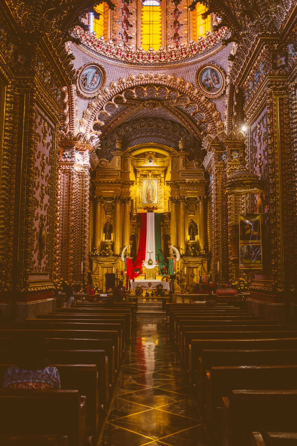 the interior of a church with gold and red decorations