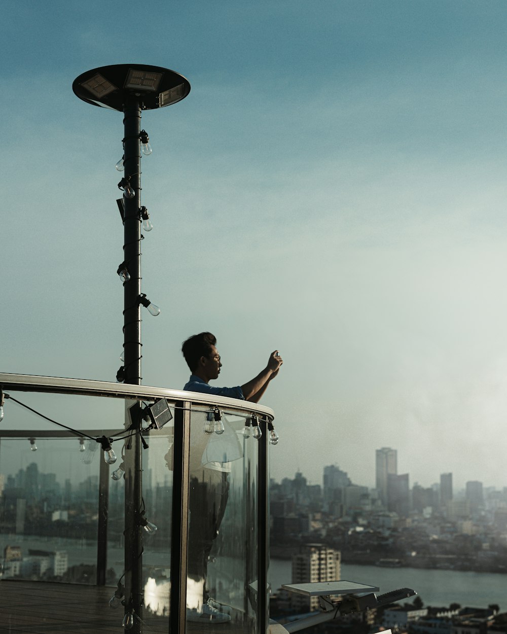 a man standing on top of a tall building