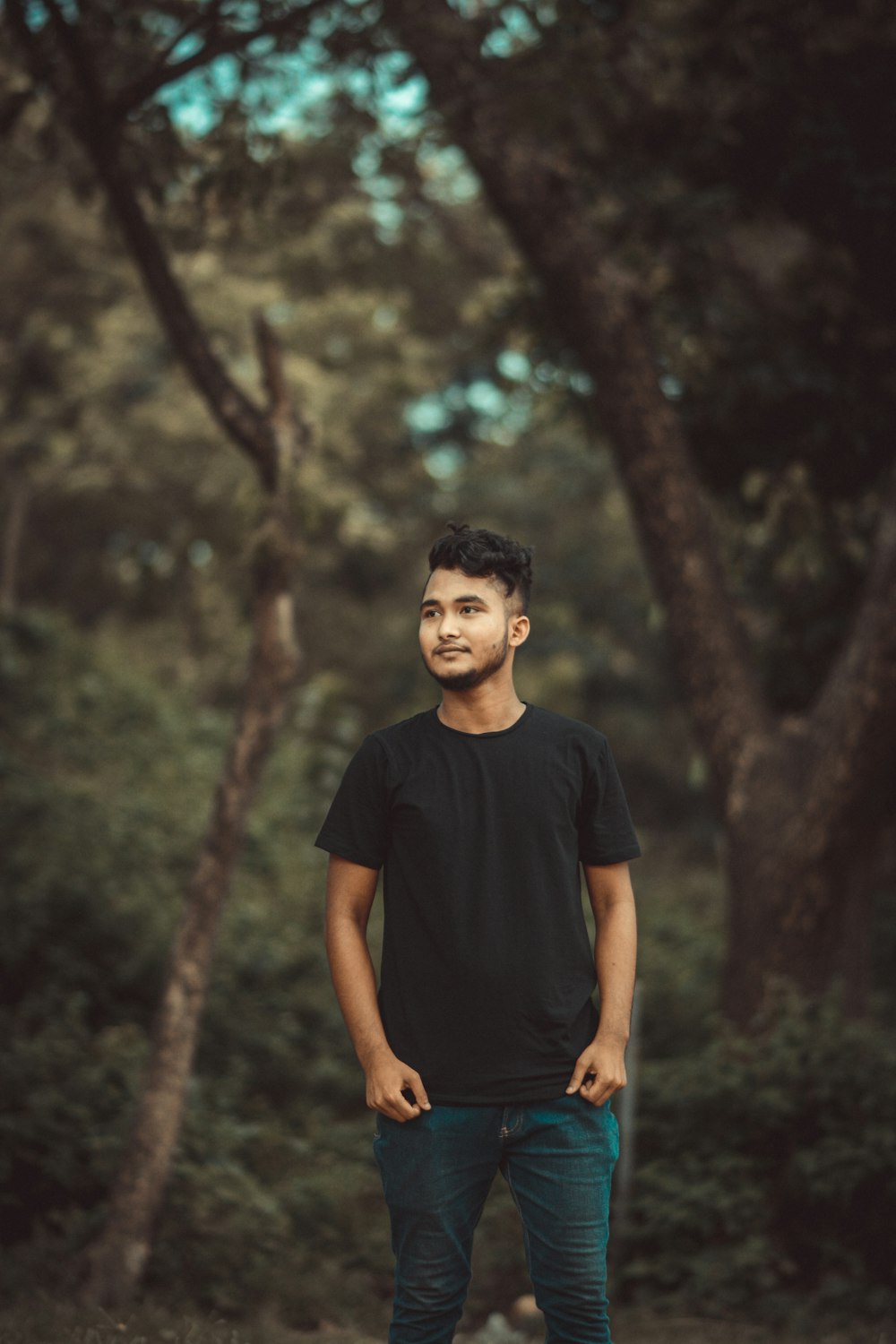 a man standing in the middle of a forest