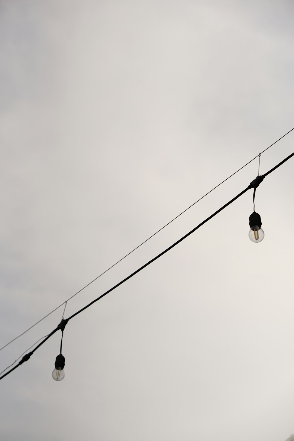 a couple of street lights hanging from a wire