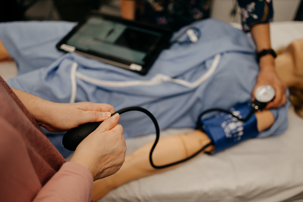 a person laying on a bed with a stethoscope