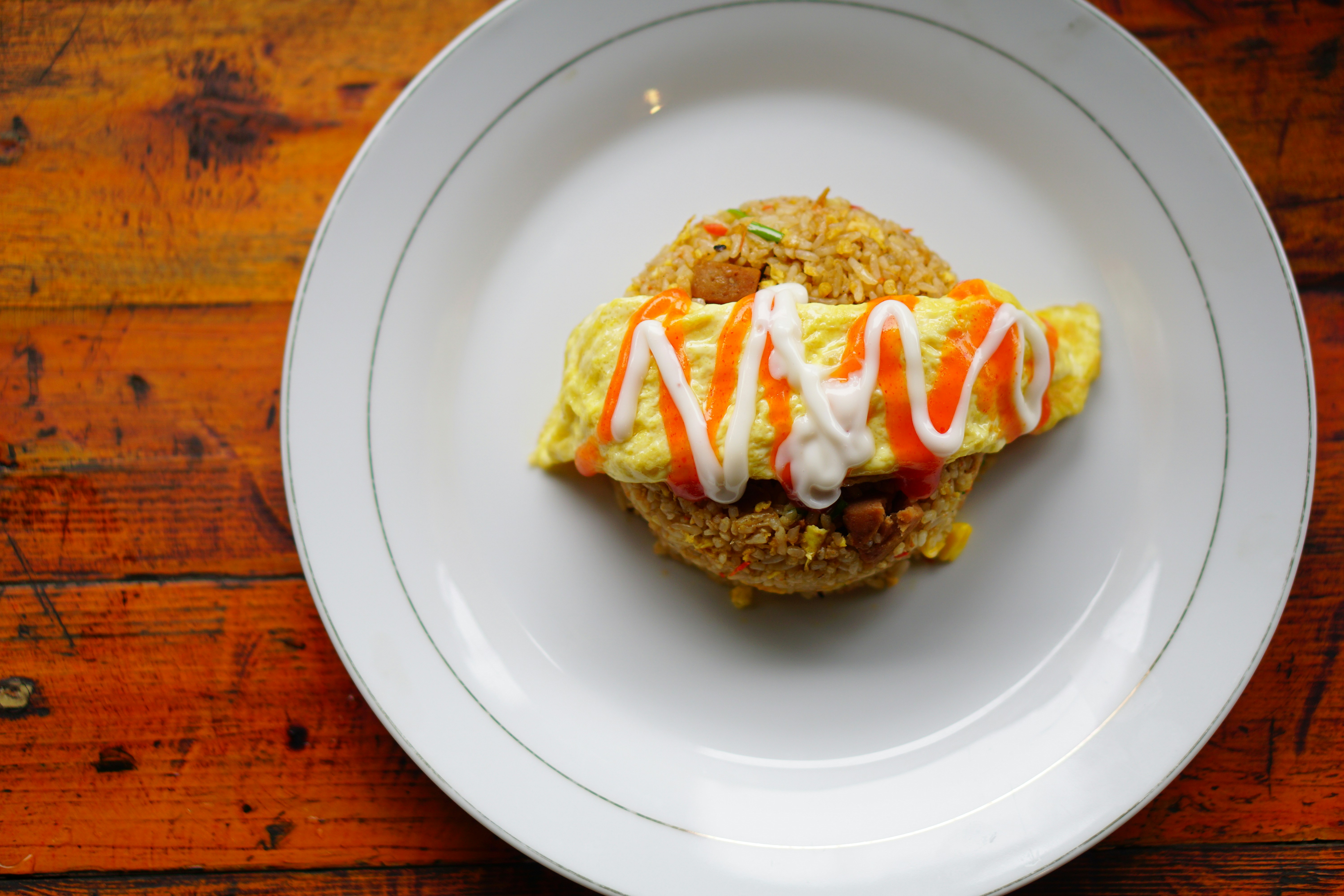 a white plate topped with a pastry covered in icing