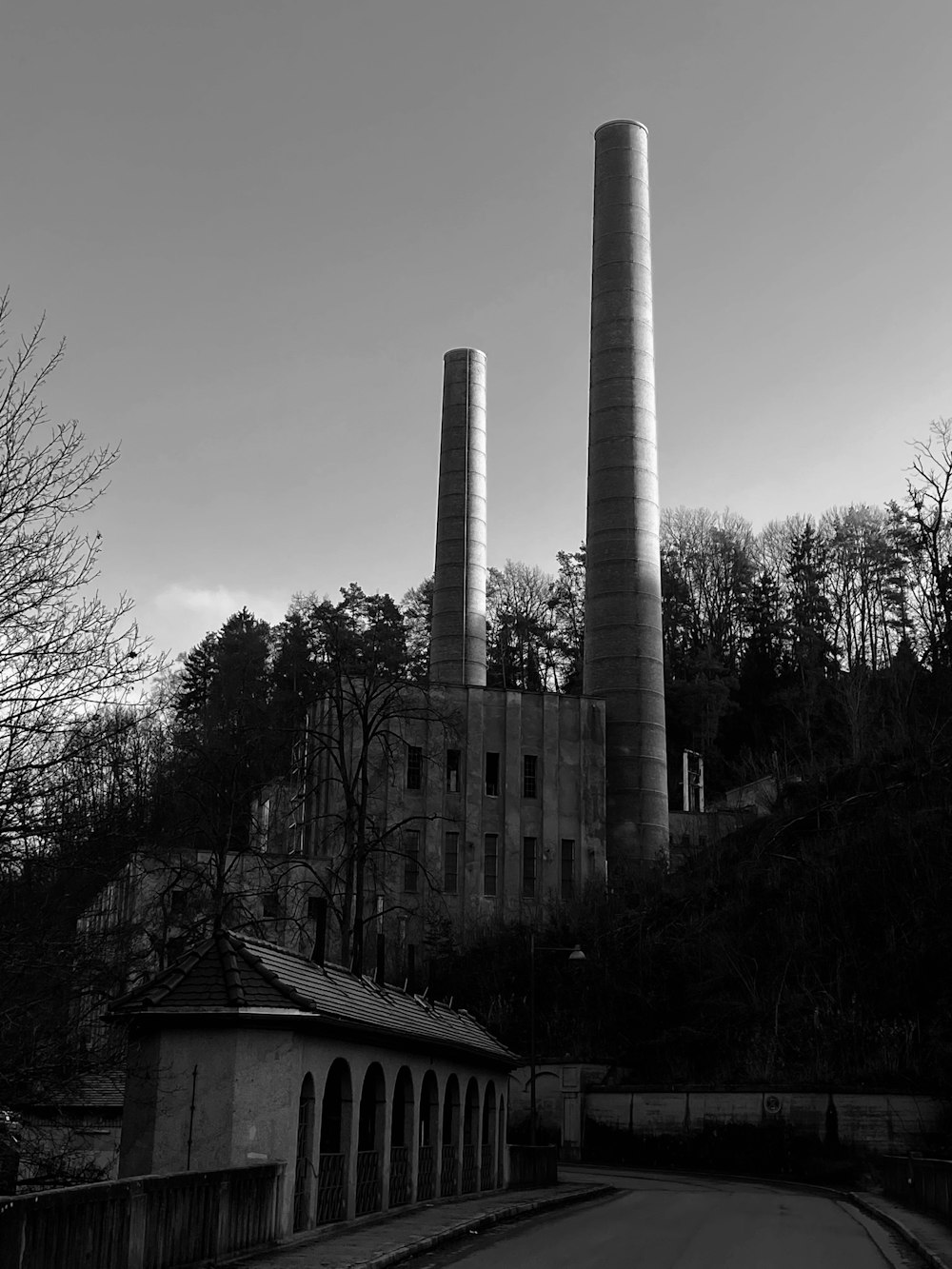 a black and white photo of two smoke stacks