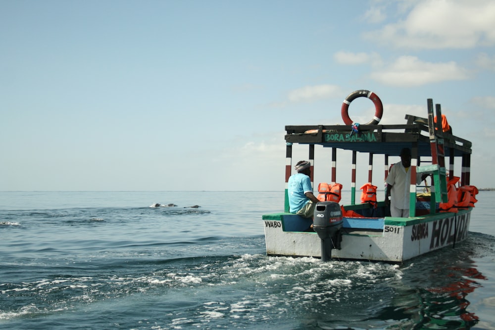 a man sitting on a boat in the ocean