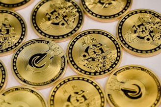 a pile of gold coin sitting on top of a table
