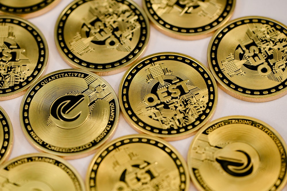 a pile of gold coin sitting on top of a table