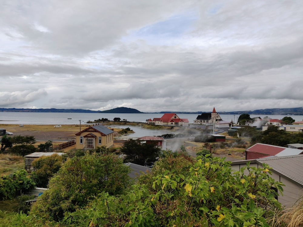 a view of a town with a body of water in the background