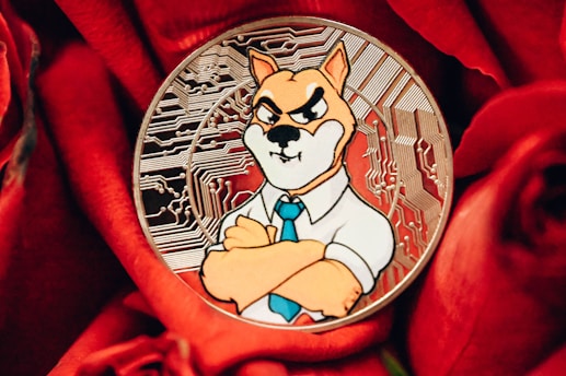 A coin featuring a cartoonish dog character wearing a shirt and tie with a stern expression, set against a background of intricate circuit patterns. The coin is placed on vibrant red roses, creating a contrast between the metallic and organic textures.