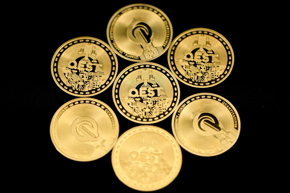 a group of five gold coins sitting on top of each other