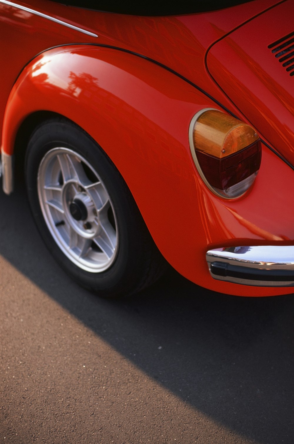 a close up of the front end of a red sports car