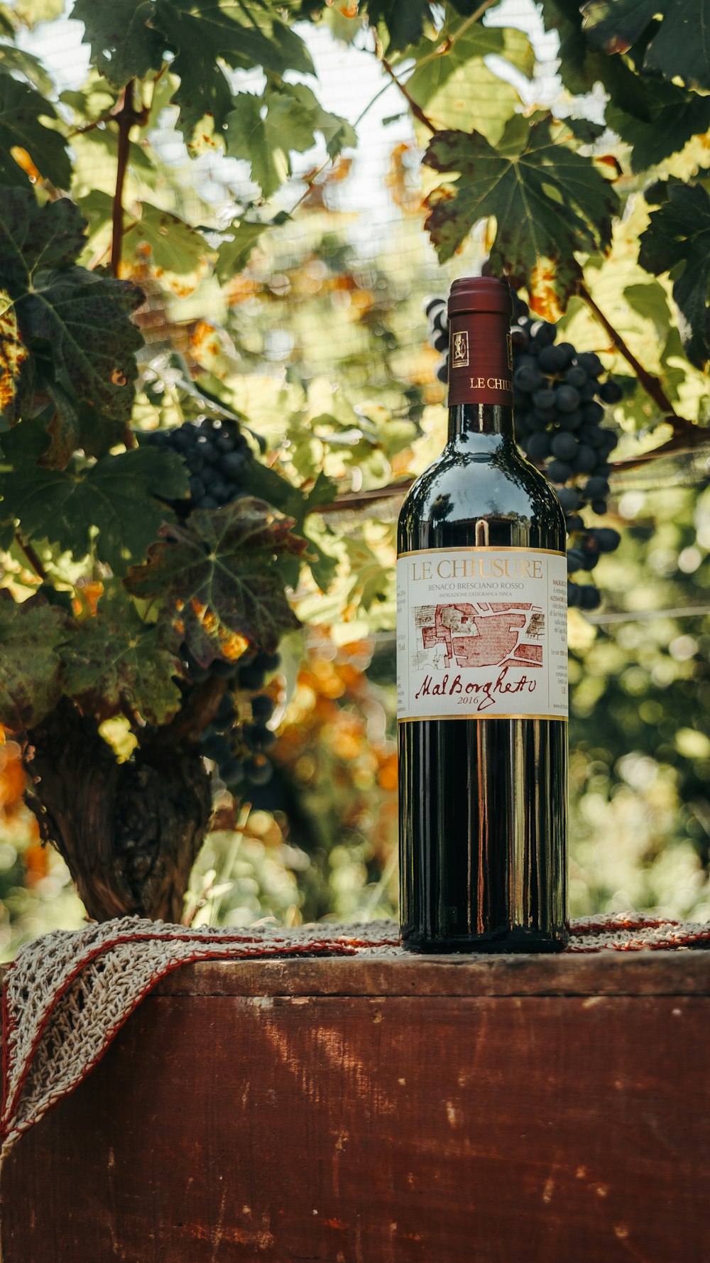 a bottle of wine sitting on top of a wooden table