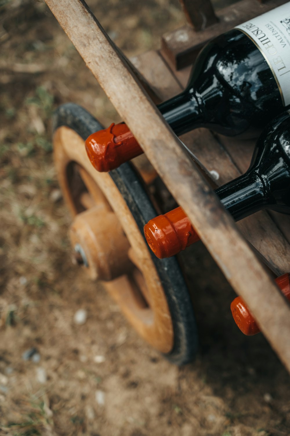 a wooden wagon with two bottles of wine in it