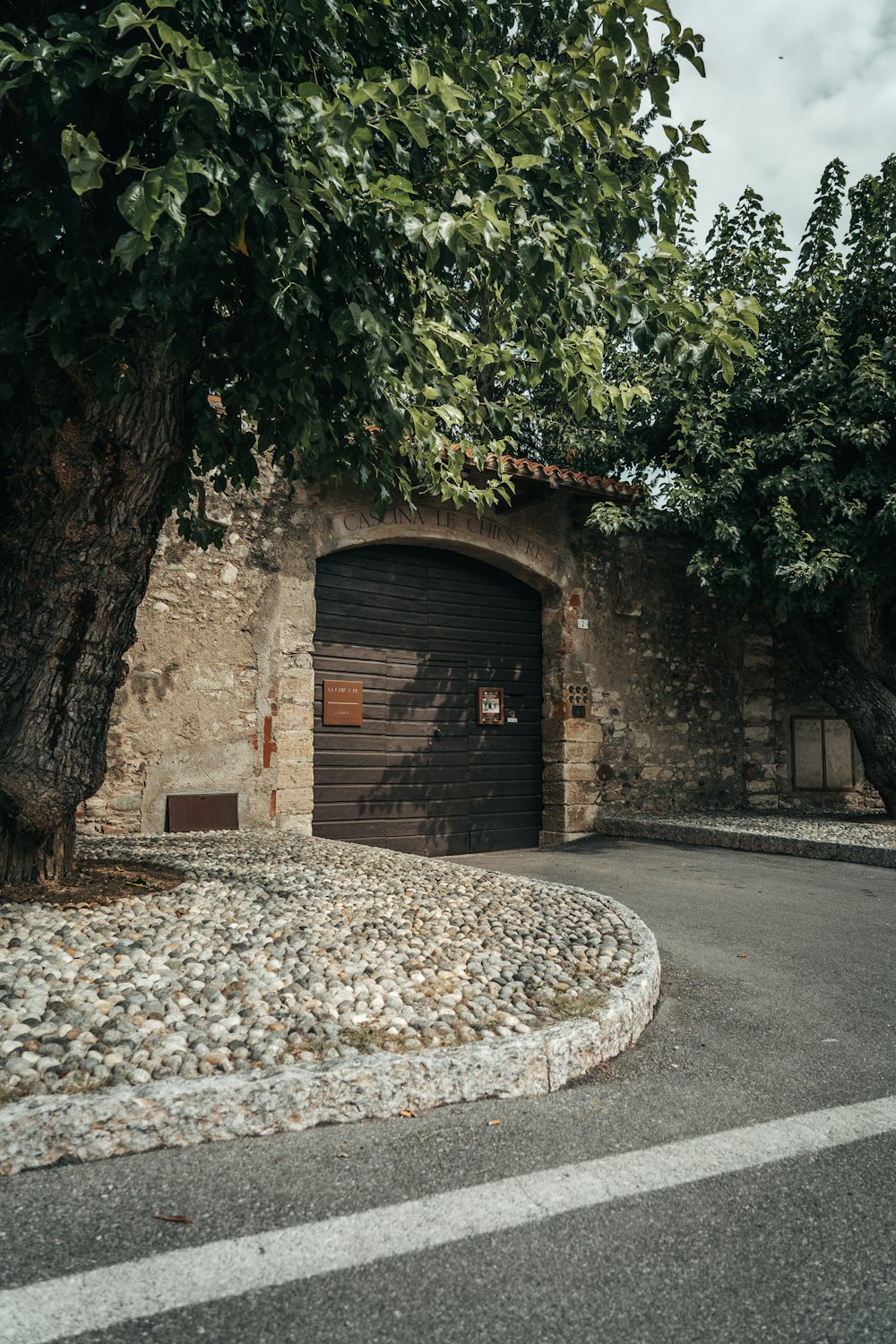 a stone building with a tree in front of it