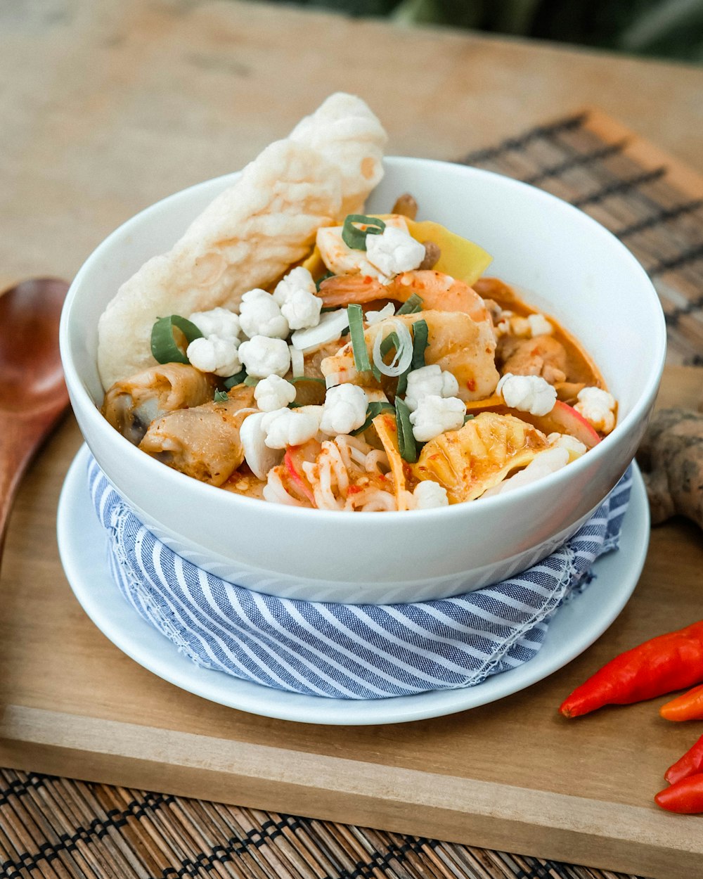 a bowl of food on a plate with a spoon