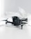 A black quadcopter drone with four propellers is placed on white crumpled paper. The drone features a camera at its front and has red and silver accents on its propellers. The background is a soft white, creating a clean and minimalistic setting.