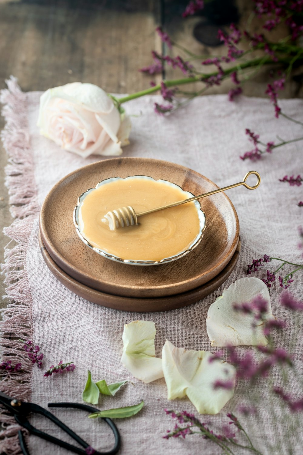 a wooden plate with a honey dip on it