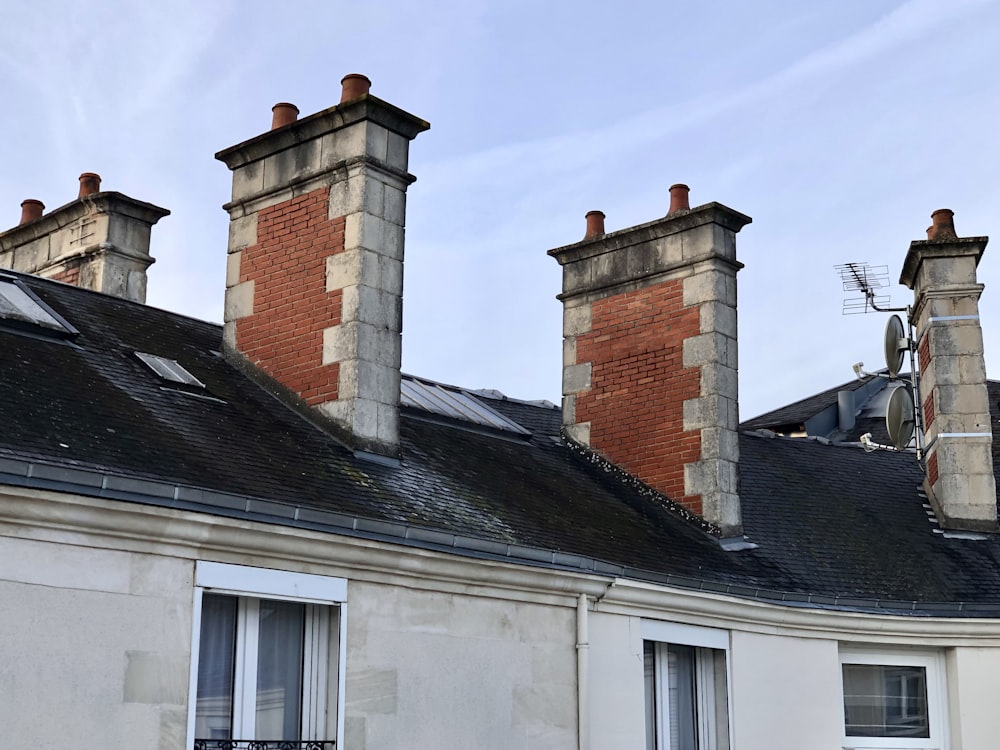 a row of chimneys on top of a building