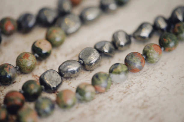 Close-up of a chunky handmade necklace with vibrant colors and textured beads.