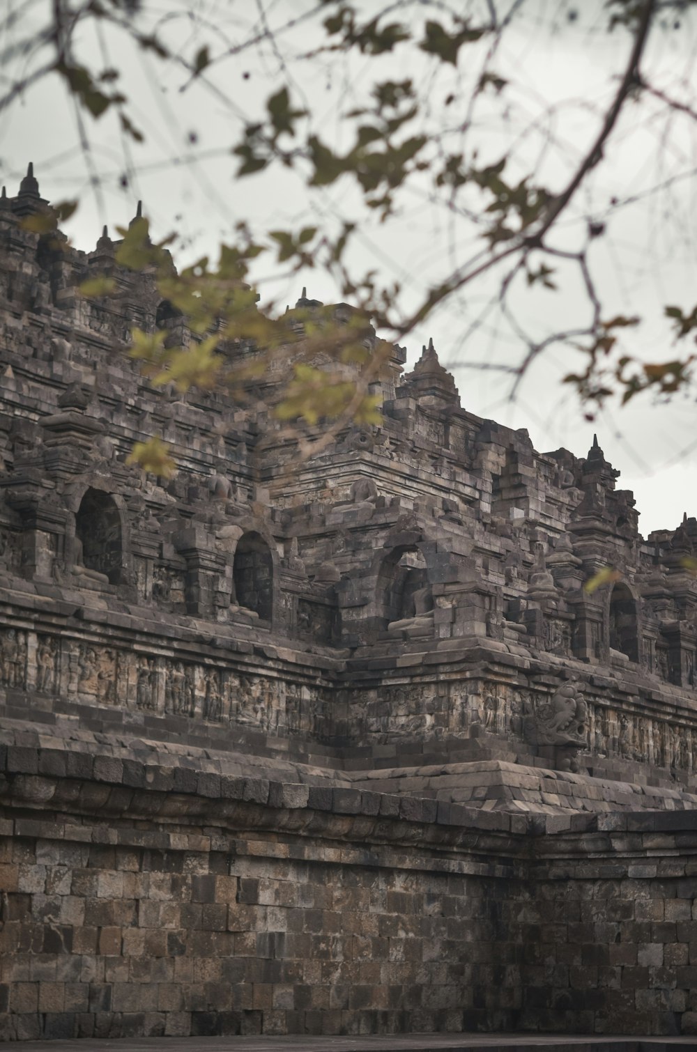 a large stone building with a clock on it's side