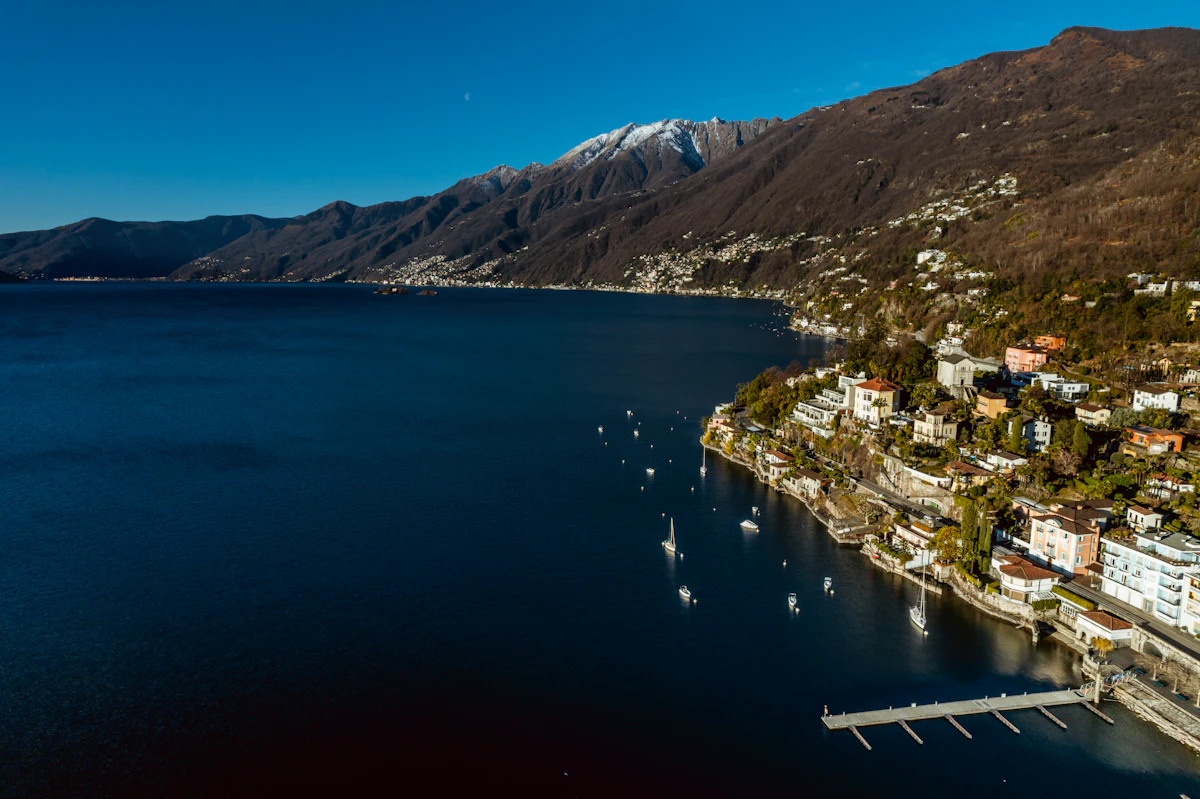 Aerial view of a lakeside Swiss town surrounded by mountains, Lago Maggiore, Switzerland