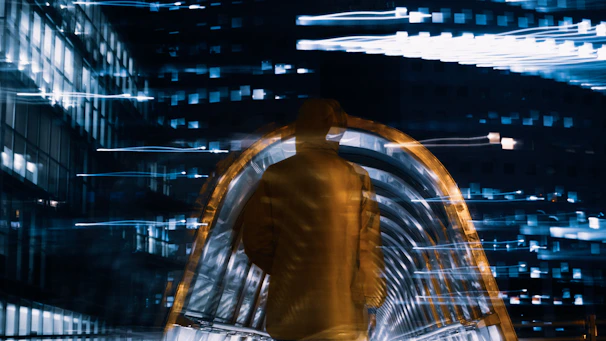 Dynamic shot of a person in a neon blue oversized sweatshirt walking through a futuristic cityscape.