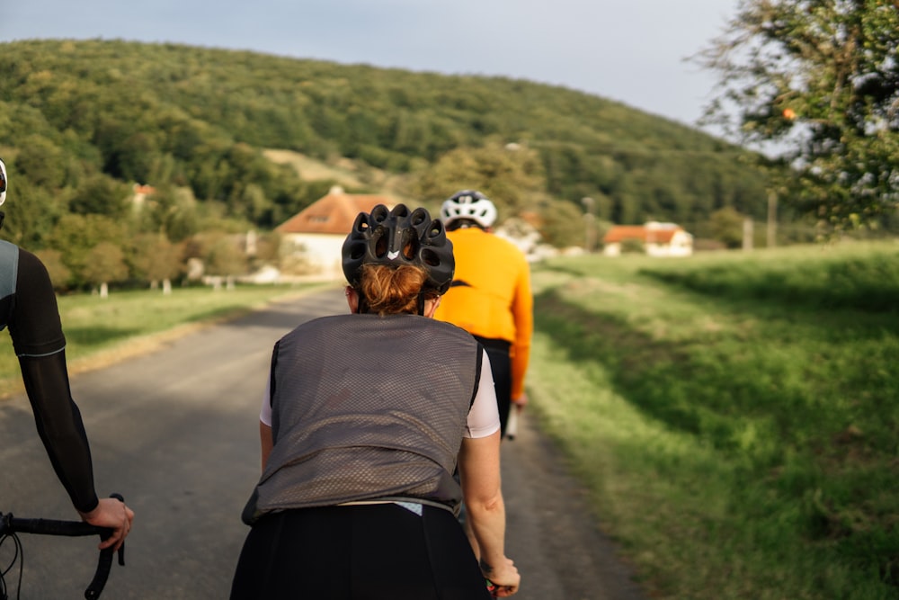 a group of people riding bikes down a road