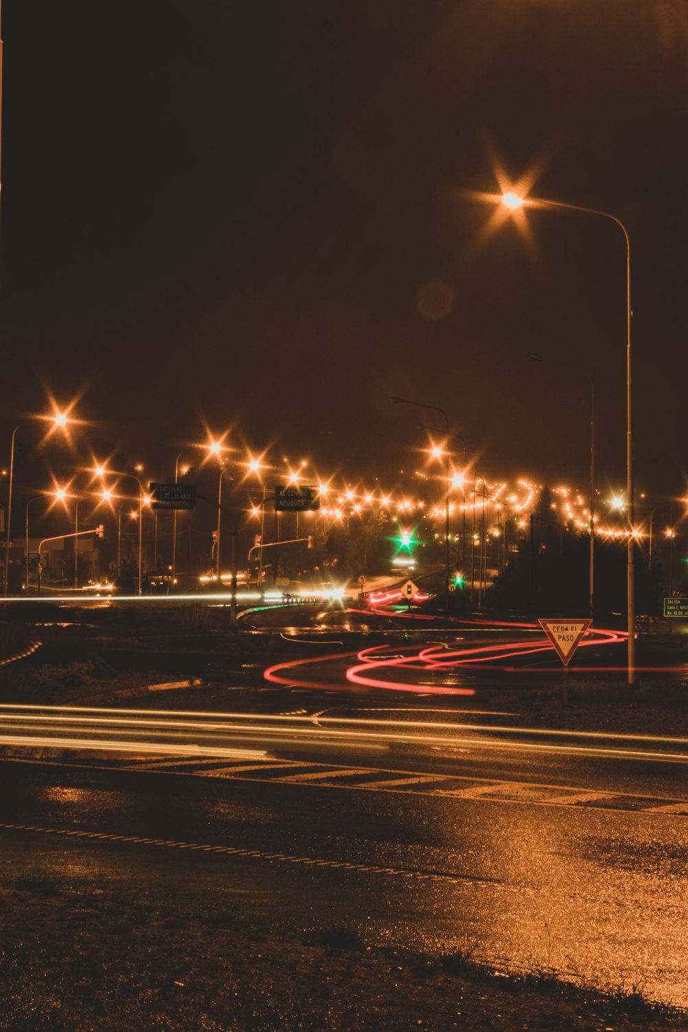 a city street filled with lots of traffic at night